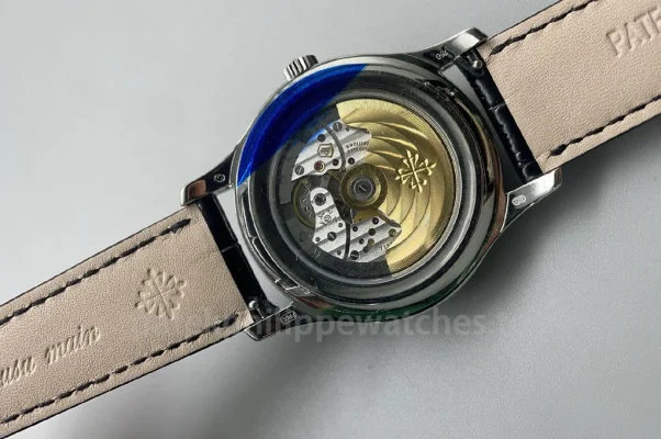 Patek Philippe Complications 5205G-001 Replica automatic watch with transparent case back showing mechanical movement and black leather strap